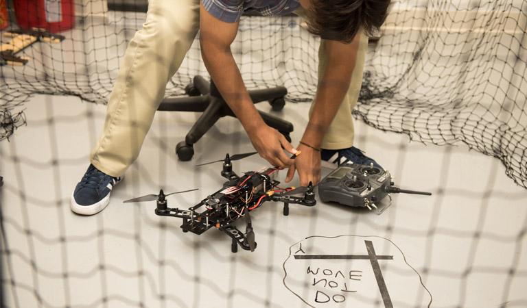 Student working on a drone